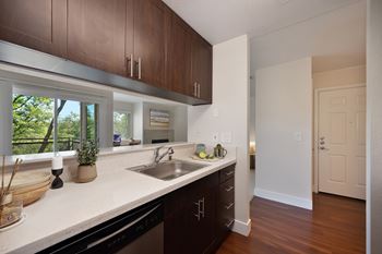 A kitchen with brown cabinets and a white counter top.